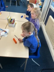 Year 4 Glow-Worms Music lesson with children listening to instructions with chime bars in front of them