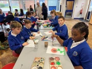 Sinfield Reward Day children sat at a table drawing and painting pictures
