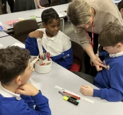 Cardiologist helping children use a stethoscope