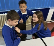 Children working together to hear a heartbeat