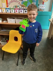 Year one child showing a hand puppet he made