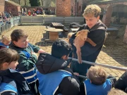 children visiting the goats at the farm.