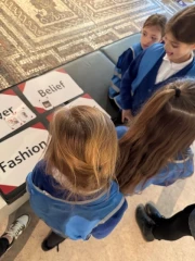 Four children looking at Roman mosaic.